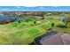 Beautiful aerial view of a lush golf course and the property's screened in lanai and swimming pool at 1736 Suzi St, Punta Gorda, FL 33950
