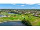 Scenic aerial view of the community, showcasing its proximity to a lake, lush greenery, and golf course at 1736 Suzi St, Punta Gorda, FL 33950