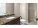 Bathroom with granite vanity, toilet, and tiled shower at 1736 Suzi St, Punta Gorda, FL 33950