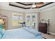 Bedroom features a ceiling fan, a treadmill, and views of the golf course and pool at 1736 Suzi St, Punta Gorda, FL 33950