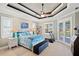 Bright bedroom with a ceiling fan, a treadmill, and doors leading to the pool at 1736 Suzi St, Punta Gorda, FL 33950