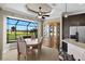 Charming dining area with beautiful views of the golf course and backyard through expansive windows at 1736 Suzi St, Punta Gorda, FL 33950