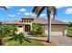 Lovely home exterior with well-maintained lawn, terracotta roofing, and an attached two-car garage at 1736 Suzi St, Punta Gorda, FL 33950