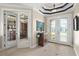 Welcoming foyer with tile flooring, decorative ceiling, and glass doors leading to office and outdoor views at 1736 Suzi St, Punta Gorda, FL 33950
