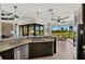 Open kitchen area with views of the golf course, stainless appliances, and granite counters at 1736 Suzi St, Punta Gorda, FL 33950
