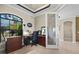 Office featuring a dark wood desk and chair, drawers, and a large window at 1736 Suzi St, Punta Gorda, FL 33950
