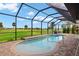 Pool with screened-in patio overlooking golf course at 1736 Suzi St, Punta Gorda, FL 33950