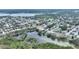 An aerial view of a neighborhood featuring properties near a serene lake at 1801 Forest Dr, Oldsmar, FL 34677