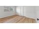 Bright bedroom with wood floors, white walls, and large windows with blinds at 1801 Forest Dr, Oldsmar, FL 34677