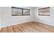 Bedroom with light wood flooring, neutral walls, and windows with horizontal blinds at 1801 Forest Dr, Oldsmar, FL 34677