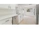 This is a modern kitchen featuring stainless steel appliances, sleek countertops, and pristine white cabinetry at 1801 Forest Dr, Oldsmar, FL 34677