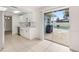 Kitchen overlooking pool area, featuring stainless steel appliances and white cabinetry at 1801 Forest Dr, Oldsmar, FL 34677