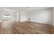 A spacious, light-filled living room featuring sleek wood flooring and crisp, white walls at 1801 Forest Dr, Oldsmar, FL 34677