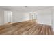 An expansive living room boasting clean, neutral walls and stylish wood-look floors at 1801 Forest Dr, Oldsmar, FL 34677