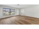 Bright, airy living room showcasing modern wood flooring and a view of the outdoors at 1801 Forest Dr, Oldsmar, FL 34677
