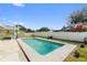 Backyard featuring a rectangular in-ground swimming pool with a grass surround at 1801 Forest Dr, Oldsmar, FL 34677