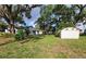 The large backyard contains an outbuilding and is adorned with mature trees, creating a private and peaceful outdoor space at 1802 19Th W Ave, Bradenton, FL 34205