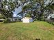 The expansive backyard has an outbuilding, and is adorned with mature trees, set in a tranquil, lush setting at 1802 19Th W Ave, Bradenton, FL 34205