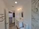 Bathroom featuring a white vanity and a tile wall that complements the wood-look flooring of the home at 1802 19Th W Ave, Bradenton, FL 34205