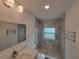 Bathroom featuring marble-style tile in the shower, contrasting with the modern vanity and fixtures at 1802 19Th W Ave, Bradenton, FL 34205