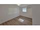 Clean bedroom with AC, two windows with bright light, and clean neutral walls and floors at 1802 19Th W Ave, Bradenton, FL 34205