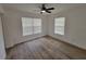 This is a cozy bedroom with wood-look flooring, featuring two windows for ample natural light at 1802 19Th W Ave, Bradenton, FL 34205