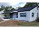 Charming single-story home showcasing a white exterior, complemented by a well-maintained yard and dark roof at 1802 19Th W Ave, Bradenton, FL 34205