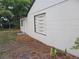 Side exterior of the home with horizontal siding details, complemented by fresh landscaping and a cozy entrance at 1802 19Th W Ave, Bradenton, FL 34205