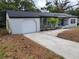 The charming home boasts a seamless blend of the garage and living areas with a welcoming stone path at 1802 19Th W Ave, Bradenton, FL 34205