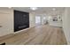 Open-concept living area with modern fireplace flows into the kitchen, all featuring stylish flooring and neutral decor at 1802 19Th W Ave, Bradenton, FL 34205