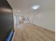Spacious living room features sleek flooring, white walls, and seamless flow into the modern kitchen at 1802 19Th W Ave, Bradenton, FL 34205