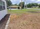 A yard with fresh mulch and rocks shows the property's landscaping potential, enhanced by surrounding greenery at 1802 19Th W Ave, Bradenton, FL 34205