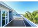 Outdoor balcony featuring a view of palm trees and neighboring homes at 211 65Th St, Holmes Beach, FL 34217