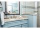 Nicely decorated bathroom featuring a shower, granite countertop and a coastal-themed mirror at 211 65Th St, Holmes Beach, FL 34217