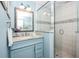 Bright bathroom featuring a glass shower, decorative tiles, and a vanity with a granite countertop at 211 65Th St, Holmes Beach, FL 34217