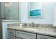 Bathroom close up featuring granite counters, sink, brushed nickel faucet, and matching wall art at 211 65Th St, Holmes Beach, FL 34217