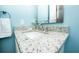 Bathroom vanity with a neutral color granite counter top, mirror, and brushed nickel faucet at 211 65Th St, Holmes Beach, FL 34217