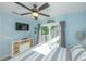 Stylish bedroom with a TV, dresser, balcony access, and soothing blue walls at 211 65Th St, Holmes Beach, FL 34217