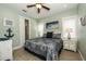 Charming bedroom features a patterned bedspread, coastal decor, and serene, light-green walls with white trim at 211 65Th St, Holmes Beach, FL 34217