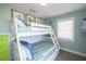 Inviting bedroom with bunk beds, mint green walls, and beach-themed decorations at 211 65Th St, Holmes Beach, FL 34217