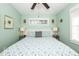 Cozy bedroom with a blue and white seashell patterned comforter, tropical decor and lots of light at 211 65Th St, Holmes Beach, FL 34217
