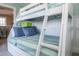 Charming bedroom with bunk beds, light green walls, and striped bedding at 211 65Th St, Holmes Beach, FL 34217