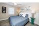 Bedroom with a queen-sized bed, white headboard, coastal decor, and lots of natural light at 211 65Th St, Holmes Beach, FL 34217