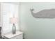 Bedroom features coastal decor, a white dresser, and a whale decoration mounted on light-green walls at 211 65Th St, Holmes Beach, FL 34217