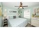 Bright bedroom with a patterned blue and white comforter, white wainscoting and tropical decor at 211 65Th St, Holmes Beach, FL 34217
