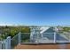 Scenic rooftop deck featuring white railings and expansive views of the surrounding area at 211 65Th St, Holmes Beach, FL 34217