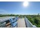 Roof deck with blue chairs and palm tree views at 211 65Th St, Holmes Beach, FL 34217