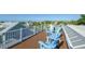 Rooftop deck with blue Adirondack chairs offering scenic neighborhood views at 211 65Th St, Holmes Beach, FL 34217