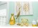Close up of tropical decor featuring golden vase, wooden heron statue and golden pineapple artwork at 211 65Th St, Holmes Beach, FL 34217