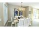 Inviting dining room with a large table set for a meal, brightened by natural light from nearby doors at 211 65Th St, Holmes Beach, FL 34217